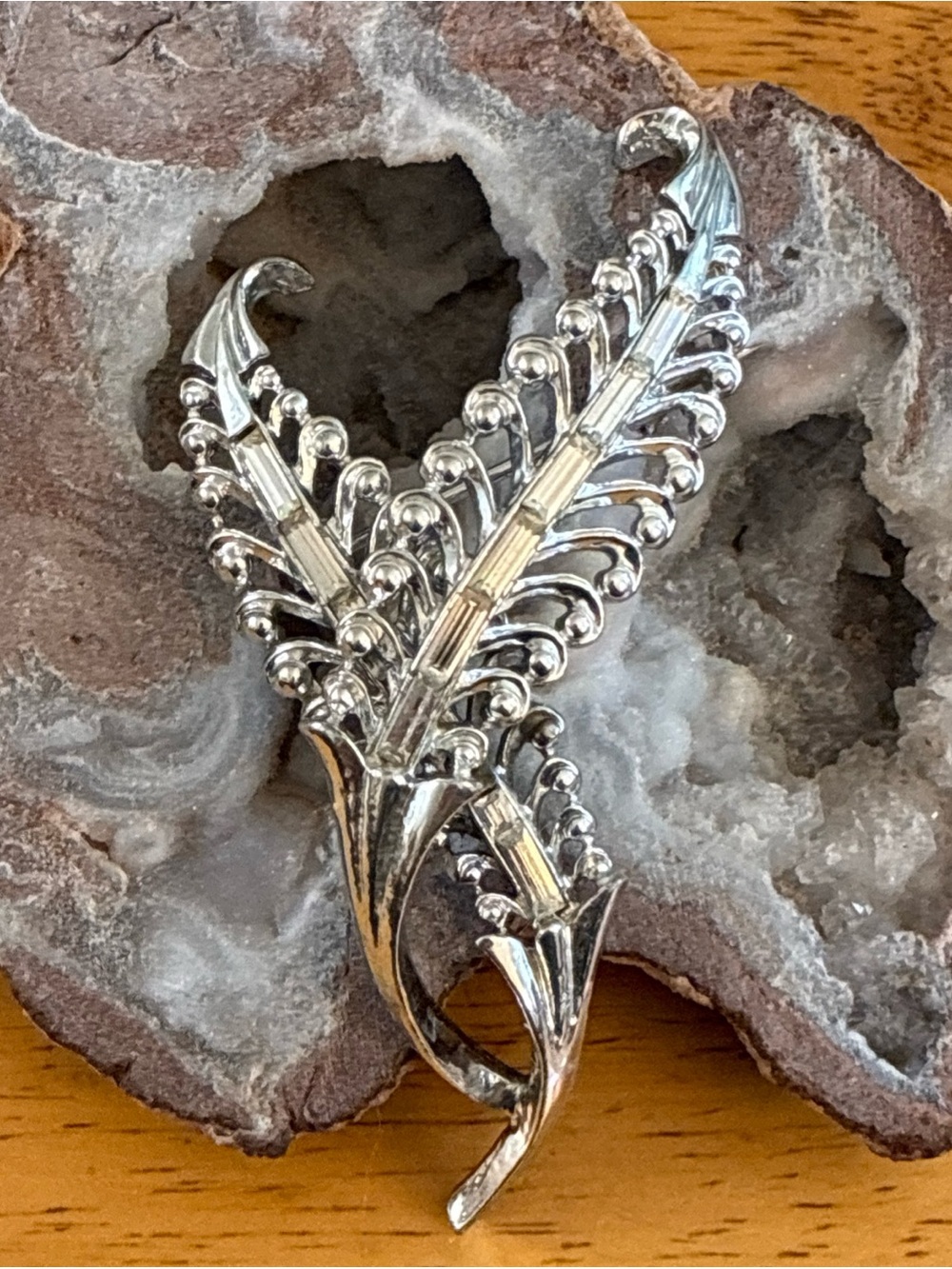 Restored Corocraft rhodium plated silver tone fern brooch with clear baguettes